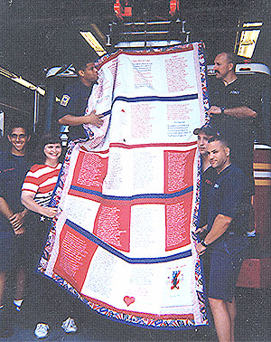 The huge amount of work needed to complete the quilt  is evident as it is unfolded at the back of the truck