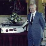 A Picture of the Queen and myself, with the 1 metre long piece of the aircraft, from which I fell.  It was presented to me at Buckingham Palace.