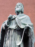 Statue of David looking heavenward with a stylus and scroll of Psalms