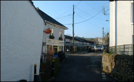 Polmewan Flats in the background, the village shop is on the left