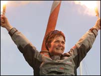 Ellen MacArthur holds up flares in celebration