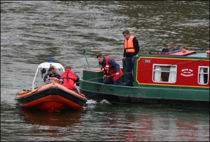 Fire tender boat arrives at the rear of the boat
