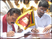 Rajapaksa (L) and JVP General Secretay signing the pre-election pact in 2005
