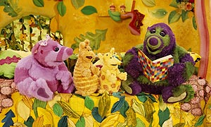 Roly Mo reading to Little Bo, Yugo and Migo