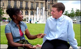 Two people chatting in the Peace Gardens