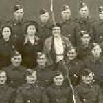 This photograph was taken after the disbanding parade of our Company.  Three ladies are with them.  I am the one in the middle of the three.