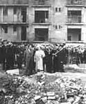 Image of the Queen Mother surveying blitz damage in the East End