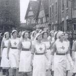 Jean Millington is 3rd from the front, without a red cross.  She wrote 'I hadn't passed my exams at this point so had to unpick the cross from my apron'.