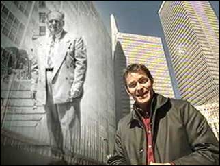 Morland Sanders standing next to a picture of Albert Osborne