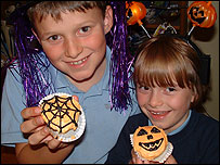 Picture: Boy and girl show off their Hallowe'en cakes