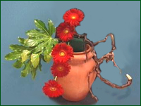 Place Gerbera flowers in to the oasis in a straight line