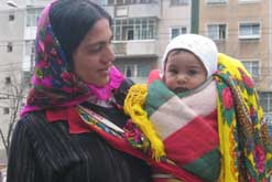 Roma young woman with baby in Bucharest