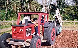 Pic: Children in a play red tractor.