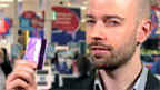 Chris with a swipe card in the supermarket