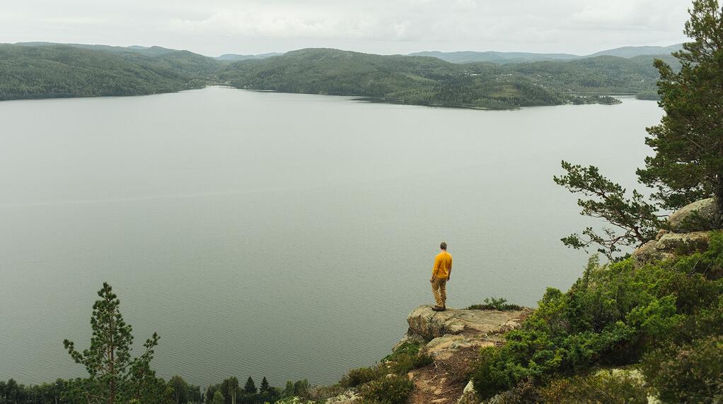 Man looking out across a lake